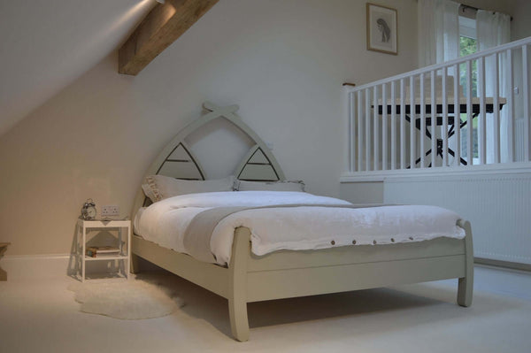 Handmade wooden bed with curved arched planked headboard