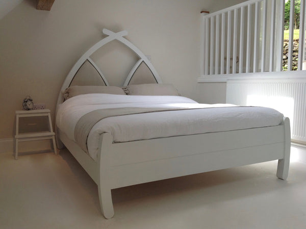 Handmade wooden bed with linen headboard