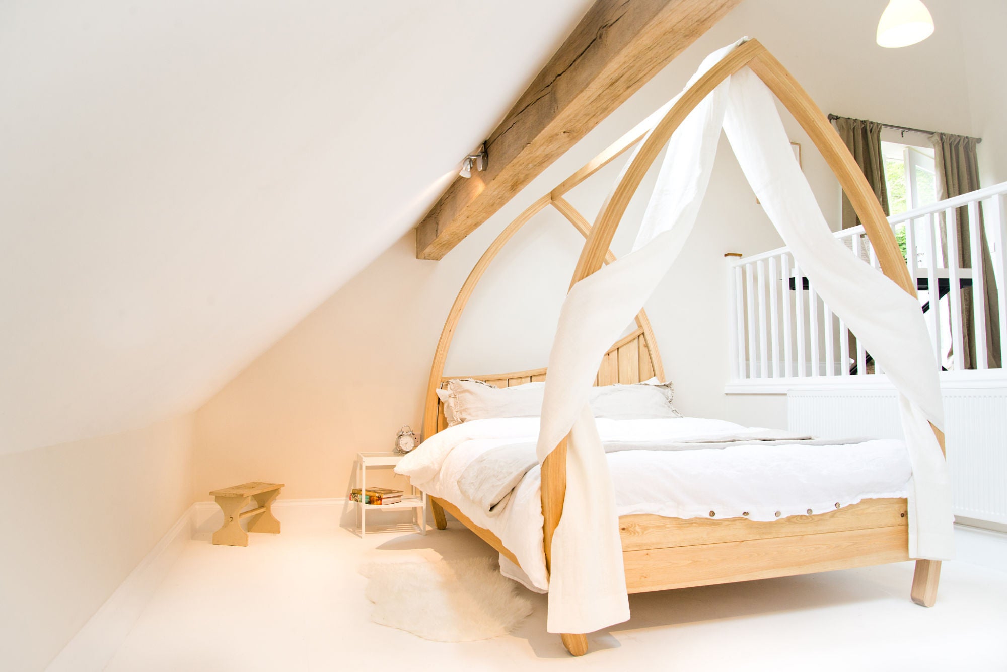 Modern four poster bed with drapes