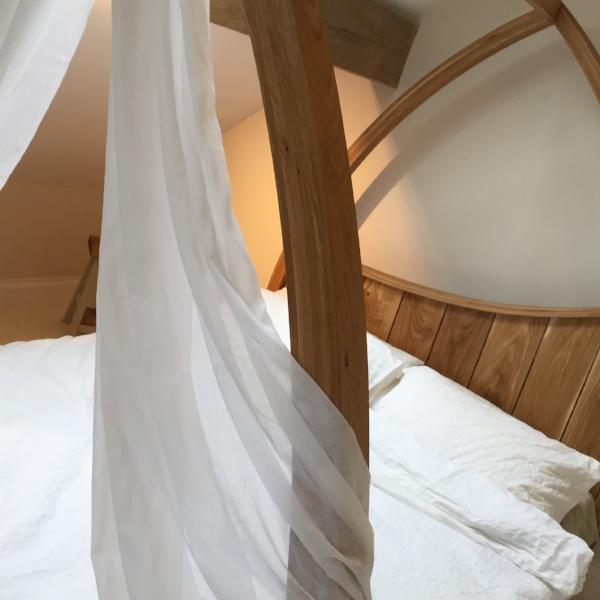 Oak Four Poster - Curved, minimal , modern design with drapes.