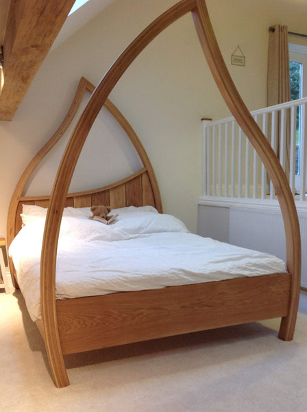 Teddy in his abowed four poster bed reading